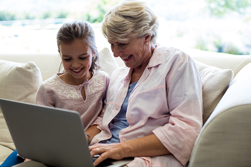 image of a woman with her grand daughter using laptop